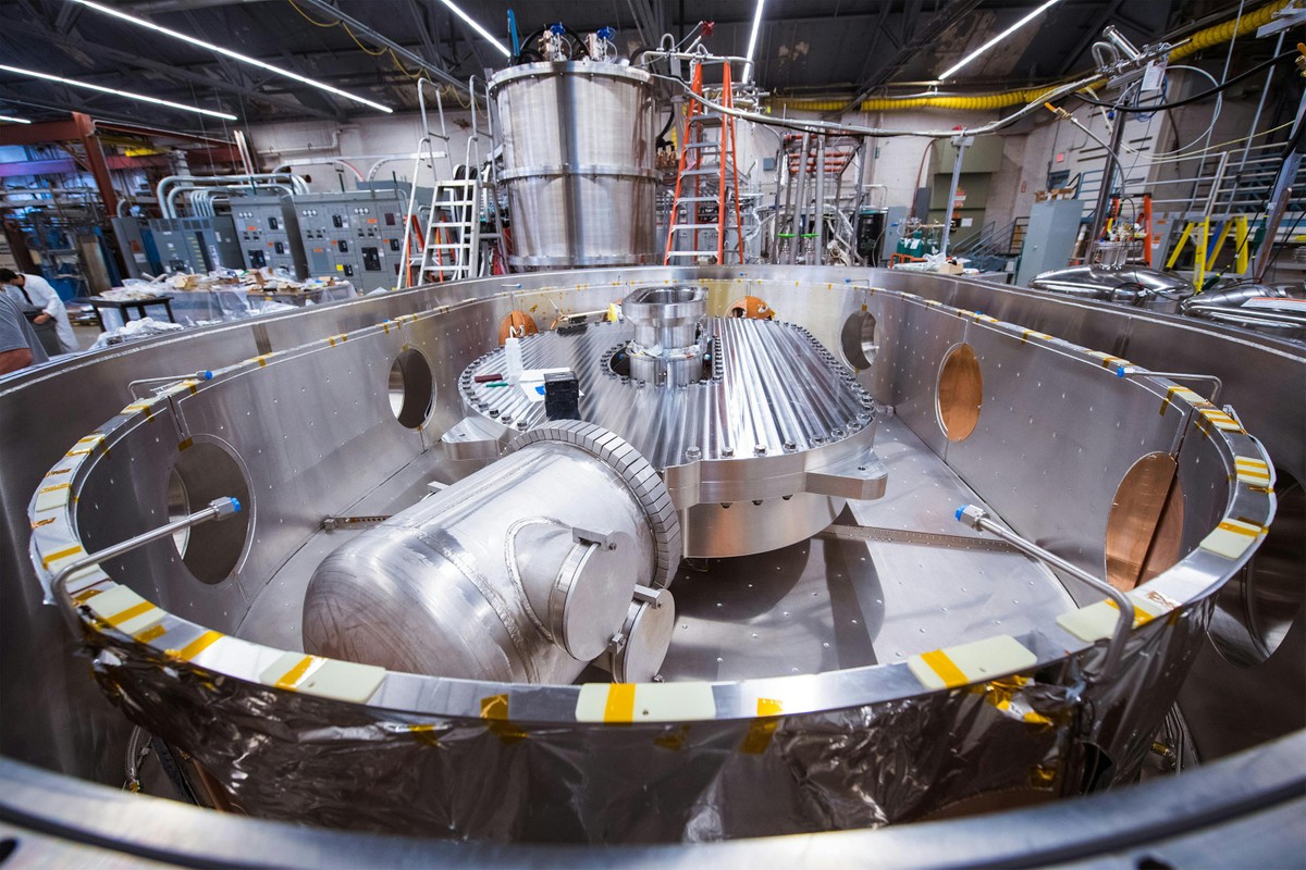 Close-up of large d-shaped magnet inside a cylindrical cryostat container